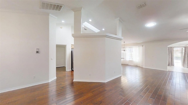 10528 SW 27th Ave, Ocala, FL 34476 - unfurnished living room with healthy amount of natural light, crown molding, arched walkways, baseboards, and dark wood-type flooring