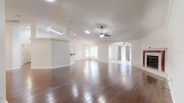 10528 SW 27th Ave, Ocala, FL 34476 - unfurnished living room featuring a ceiling fan, a premium fireplace, hardwood / wood-style floors, vaulted ceiling, and arched walkways