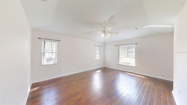 10528 SW 27th Ave, Ocala, FL 34476 - spare room with healthy amount of natural light, ceiling fan, baseboards, and dark wood-style floors