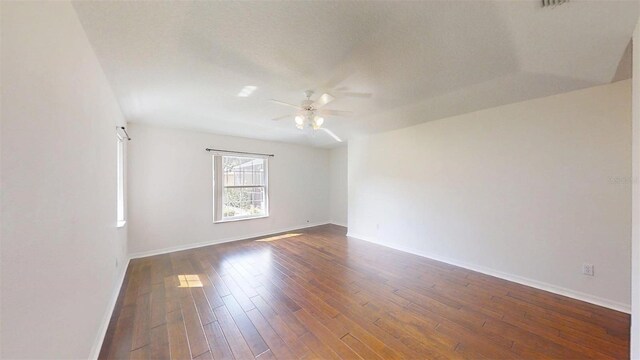 10528 SW 27th Ave, Ocala, FL 34476 - empty room with ceiling fan, dark wood-style floors, and baseboards