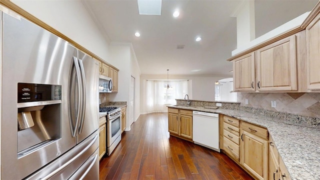10528 SW 27th Ave, Ocala, FL 34476 - kitchen with stainless steel appliances, light brown cabinetry, a peninsula, ornamental molding, and light stone countertops
