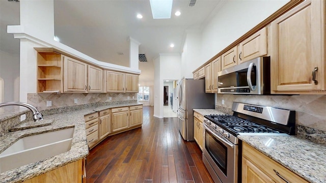 10528 SW 27th Ave, Ocala, FL 34476 - kitchen with stainless steel appliances, a sink, light brown cabinetry, open shelves, and light stone countertops