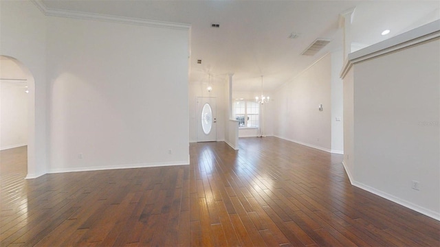 10528 SW 27th Ave, Ocala, FL 34476 - unfurnished living room with arched walkways, a chandelier, dark wood-type flooring, ornamental molding, and baseboards