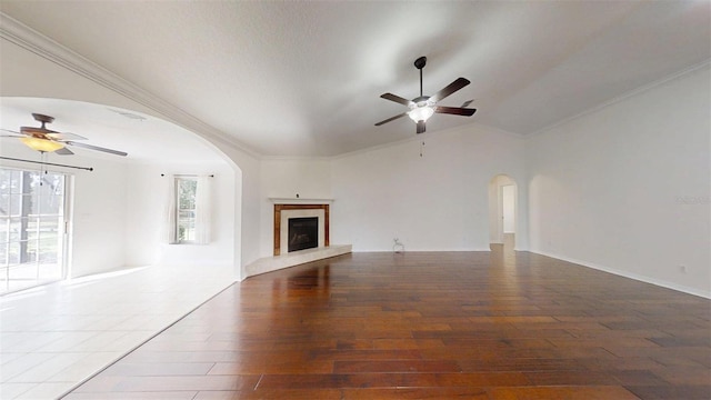 10528 SW 27th Ave, Ocala, FL 34476 - unfurnished living room with a ceiling fan, arched walkways, vaulted ceiling, wood finished floors, and a high end fireplace