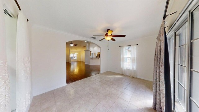 10528 SW 27th Ave, Ocala, FL 34476 - unfurnished room with a ceiling fan, arched walkways, light tile patterned floors, and crown molding