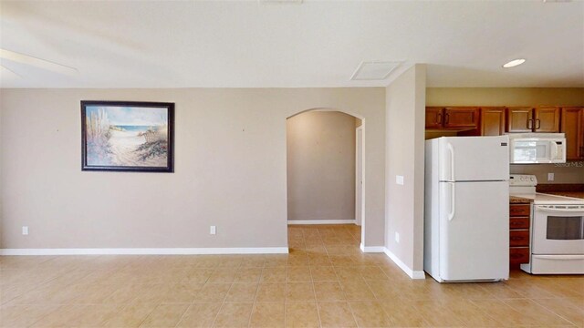 10528 SW 27th Ave, Ocala, FL 34476 - kitchen with white appliances, arched walkways, brown cabinetry, baseboards, and recessed lighting