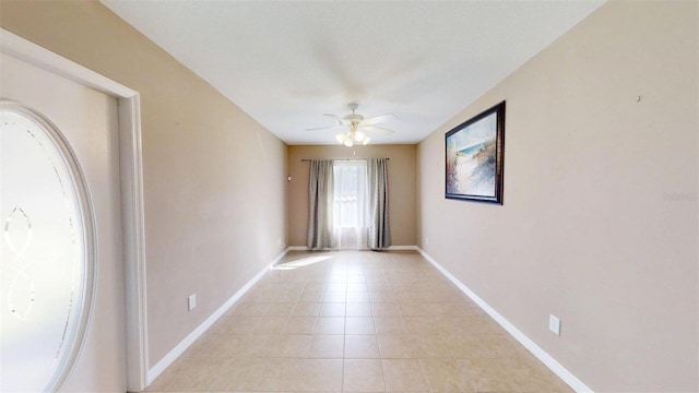 10528 SW 27th Ave, Ocala, FL 34476 - spare room featuring a ceiling fan, light tile patterned floors, and baseboards