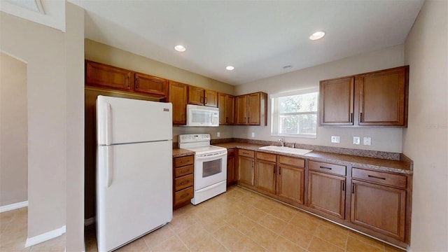 10528 SW 27th Ave, Ocala, FL 34476 - kitchen featuring white appliances, brown cabinetry, a sink, recessed lighting, and light tile patterned floors