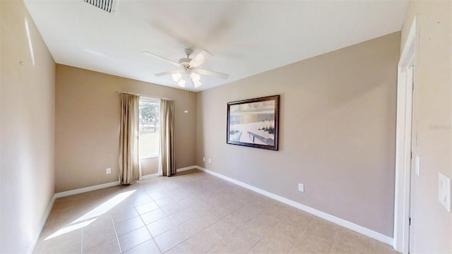 10528 SW 27th Ave, Ocala, FL 34476 - spare room with a ceiling fan, light tile patterned floors, and baseboards