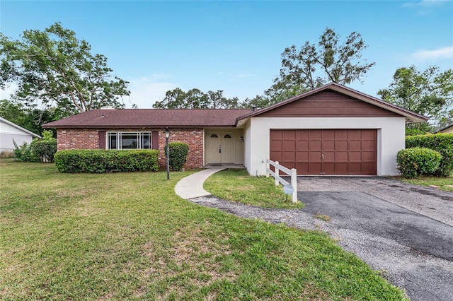 2146 NE 9th St, Ocala, FL 34470 - ranch-style home featuring an attached garage, asphalt driveway, a front lawn, and brick siding