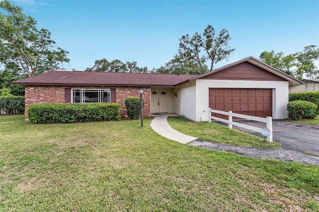 2146 NE 9th St, Ocala, FL 34470 - single story home featuring a garage, a front yard, driveway, and brick siding