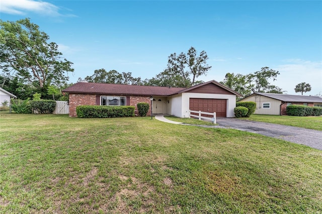 2146 NE 9th St, Ocala, FL 34470 - ranch-style home with an attached garage, driveway, and brick siding