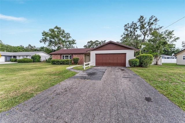 2146 NE 9th St, Ocala, FL 34470 - ranch-style house with an attached garage, driveway, a front lawn, and brick siding