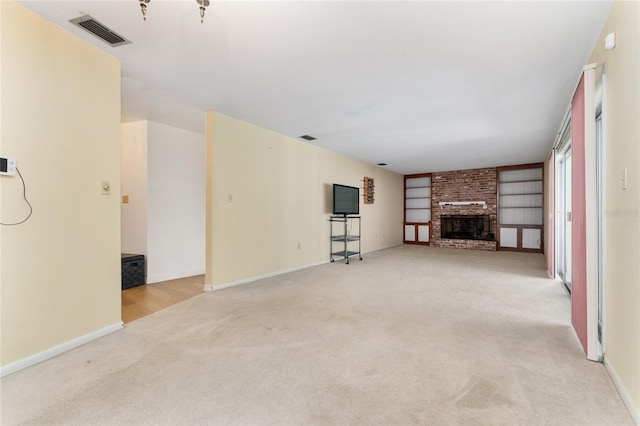 2146 NE 9th St, Ocala, FL 34470 - unfurnished living room featuring light carpet, a brick fireplace, and baseboards