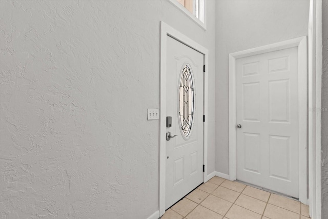3728 S Eastpark Way, Homosassa, FL 34446 - entrance foyer with light tile patterned floors, a textured wall, and baseboards