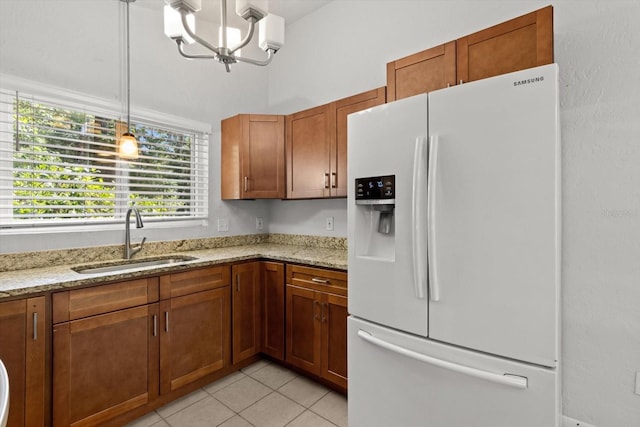 3728 S Eastpark Way, Homosassa, FL 34446 - kitchen with white refrigerator with ice dispenser, a sink, brown cabinetry, and a chandelier