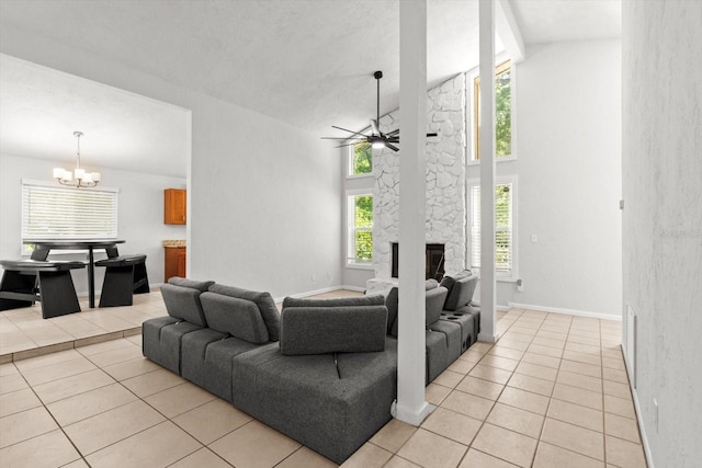 3728 S Eastpark Way, Homosassa, FL 34446 - living area with light tile patterned floors, a chandelier, a fireplace, ceiling fan, and high vaulted ceiling