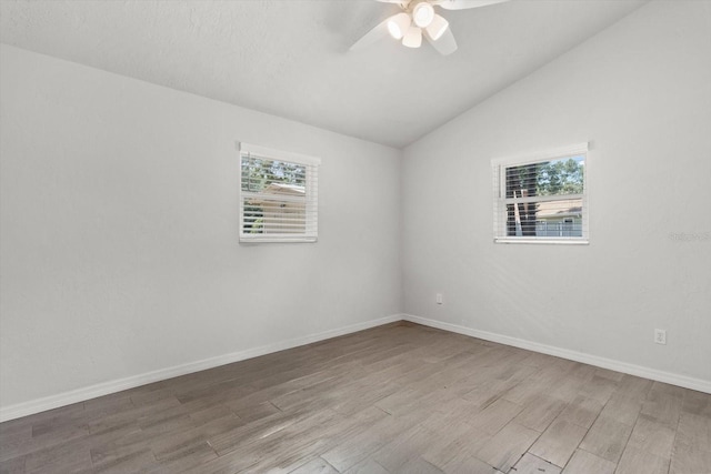 3728 S Eastpark Way, Homosassa, FL 34446 - empty room with wood finished floors, healthy amount of natural light, ceiling fan, vaulted ceiling, and baseboards