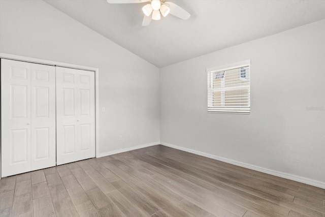 3728 S Eastpark Way, Homosassa, FL 34446 - unfurnished bedroom featuring wood finished floors, vaulted ceiling, a closet, baseboards, and ceiling fan