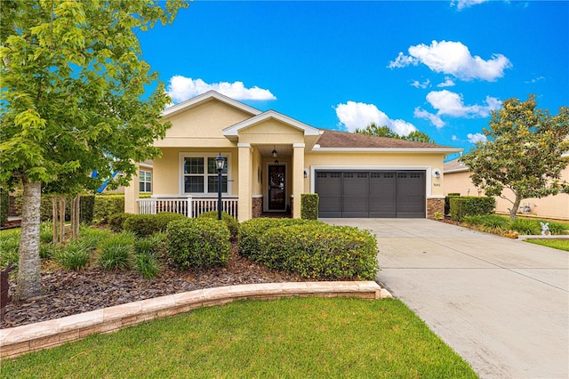 9642 SW 95th Loop, Ocala, FL 34481 - view of front of house featuring a garage, stucco siding, driveway, stone siding, and covered porch