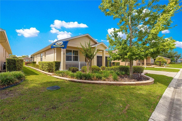 9642 SW 95th Loop, Ocala, FL 34481 - view of front of home featuring stucco siding, a front lawn, and covered porch