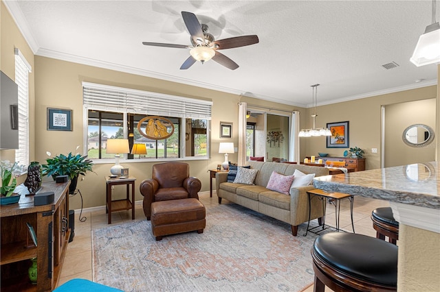 9642 SW 95th Loop, Ocala, FL 34481 - living room with light tile patterned floors, crown molding, ceiling fan, and a chandelier