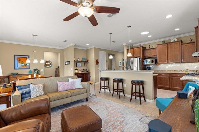 9642 SW 95th Loop, Ocala, FL 34481 - living room featuring light tile patterned floors, recessed lighting, ceiling fan, and ornamental molding