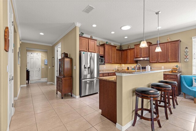 9642 SW 95th Loop, Ocala, FL 34481 - kitchen featuring stainless steel appliances, light tile patterned floors, brown cabinets, crown molding, and recessed lighting