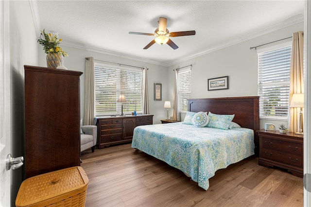 9642 SW 95th Loop, Ocala, FL 34481 - bedroom featuring ornamental molding, wood finished floors, and a ceiling fan