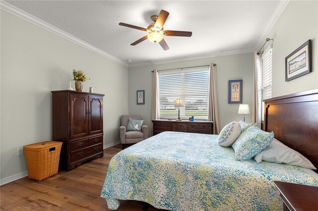 9642 SW 95th Loop, Ocala, FL 34481 - bedroom with wood finished floors, ornamental molding, and a ceiling fan