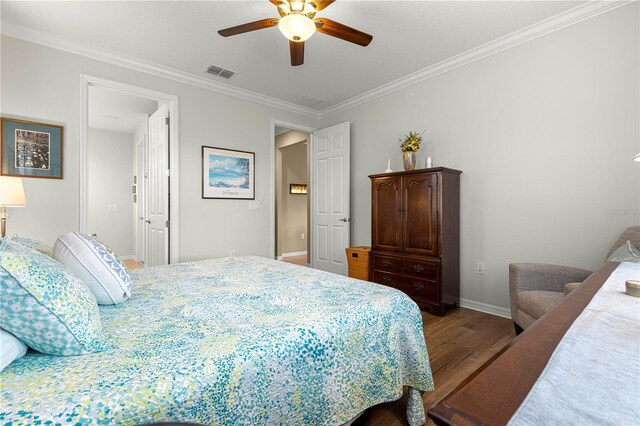 9642 SW 95th Loop, Ocala, FL 34481 - bedroom featuring wood finished floors, ornamental molding, and a ceiling fan