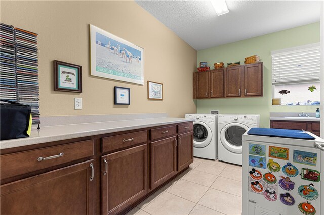 9642 SW 95th Loop, Ocala, FL 34481 - laundry area featuring independent washer and dryer, cabinet space, light tile patterned floors, and a textured ceiling