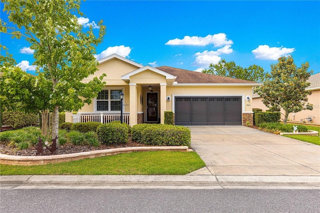 9642 SW 95th Loop, Ocala, FL 34481 - view of front of home with a garage, stucco siding, concrete driveway, a porch, and stone siding