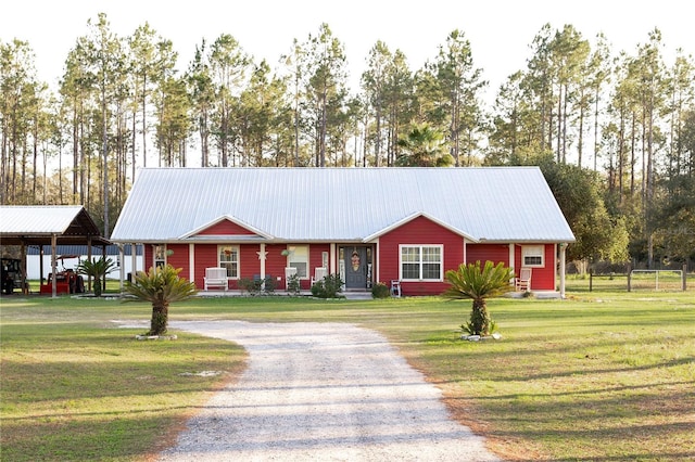 831 SE 11th Pl, Williston, FL 32696 - single story home with driveway, a front lawn, and a metal roof