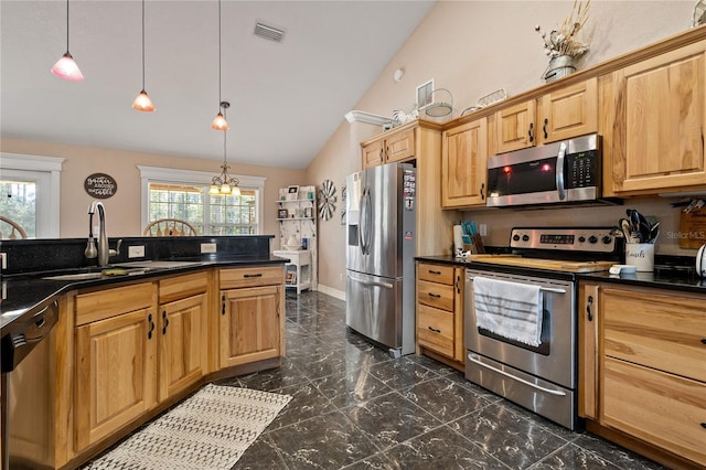 831 SE 11th Pl, Williston, FL 32696 - kitchen featuring stainless steel appliances, dark countertops, lofted ceiling, dark marble finish flooring, and hanging light fixtures