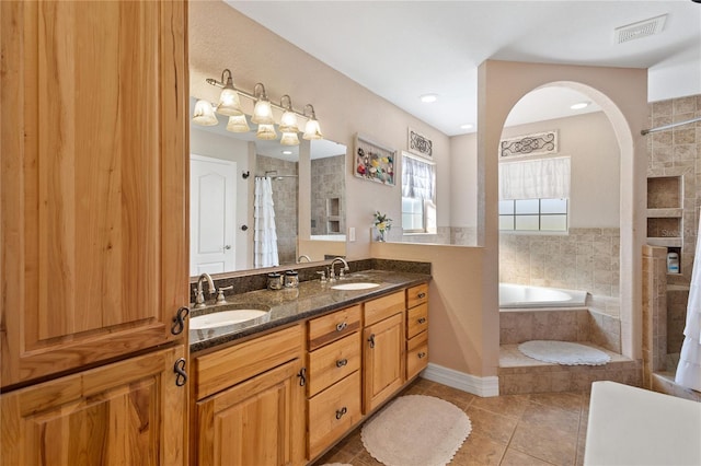 831 SE 11th Pl, Williston, FL 32696 - full bathroom featuring tiled shower, a bath, tile patterned flooring, and double vanity