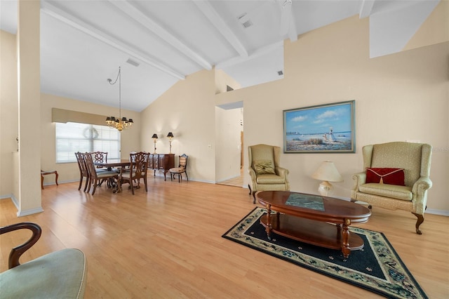11586 SW 75th Cir, Ocala, FL 34476 - living area featuring beamed ceiling, a chandelier, wood finished floors, baseboards, and high vaulted ceiling