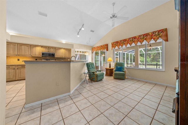11586 SW 75th Cir, Ocala, FL 34476 - kitchen featuring stainless steel microwave, lofted ceiling, light tile patterned floors, track lighting, and a peninsula