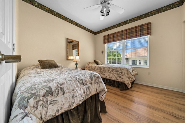 11586 SW 75th Cir, Ocala, FL 34476 - bedroom featuring wood finished floors, baseboards, and a ceiling fan