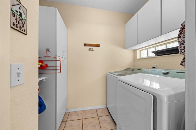 11586 SW 75th Cir, Ocala, FL 34476 - washroom featuring cabinet space, separate washer and dryer, light tile patterned floors, and baseboards