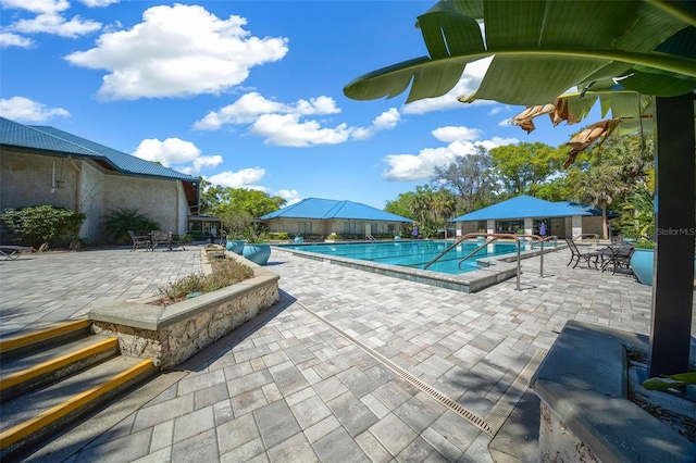 11586 SW 75th Cir, Ocala, FL 34476 - community pool with a patio area