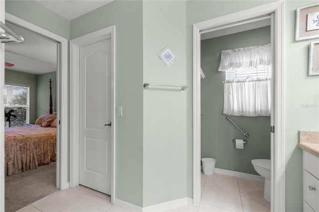 8352 SE 168th Trinity Pl, The Villages, FL 32162 - ensuite bathroom with toilet, tile patterned flooring, vanity, and baseboards