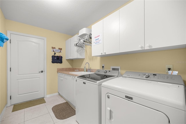 8352 SE 168th Trinity Pl, The Villages, FL 32162 - washroom featuring separate washer and dryer, cabinet space, light tile patterned floors, and baseboards