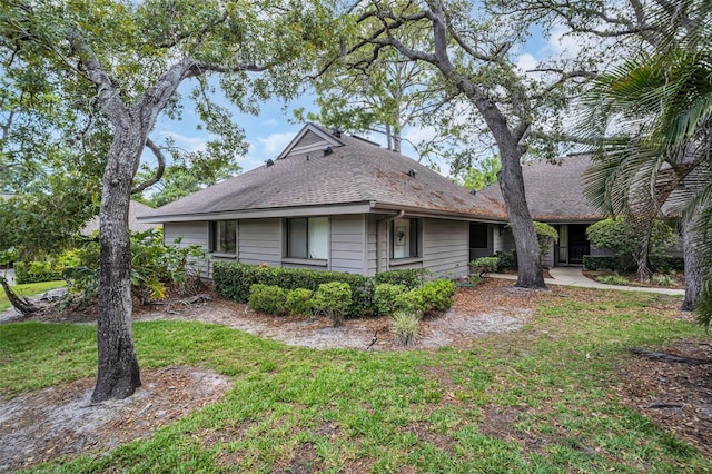 1001 Old Mill Pond Rd, Palm Harbor, FL 34683 - view of front of home with roof with shingles and a front lawn