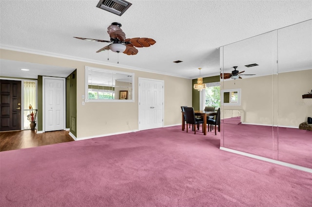 1001 Old Mill Pond Rd, Palm Harbor, FL 34683 - carpeted living area with a ceiling fan, crown molding, a textured ceiling, and baseboards