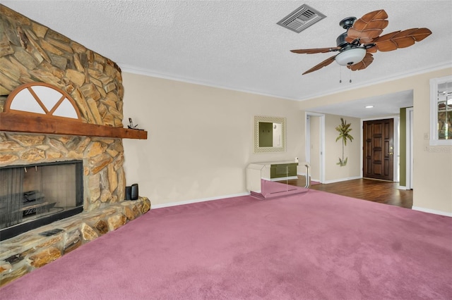 1001 Old Mill Pond Rd, Palm Harbor, FL 34683 - unfurnished living room featuring carpet, a stone fireplace, a ceiling fan, ornamental molding, and baseboards