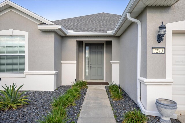 7270 SW 99th Cir, Ocala, FL 34481 - doorway to property with stucco siding and roof with shingles