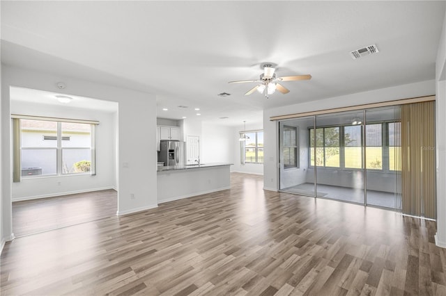 7270 SW 99th Cir, Ocala, FL 34481 - unfurnished living room with ceiling fan, wood finished floors, baseboards, and recessed lighting