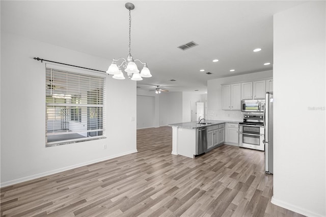 7270 SW 99th Cir, Ocala, FL 34481 - kitchen with stainless steel appliances, open floor plan, a peninsula, recessed lighting, and a chandelier