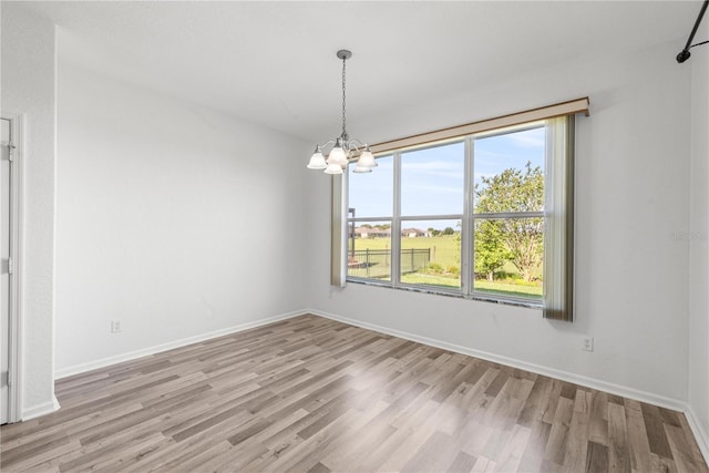 7270 SW 99th Cir, Ocala, FL 34481 - unfurnished room featuring a chandelier, light wood-style floors, and baseboards